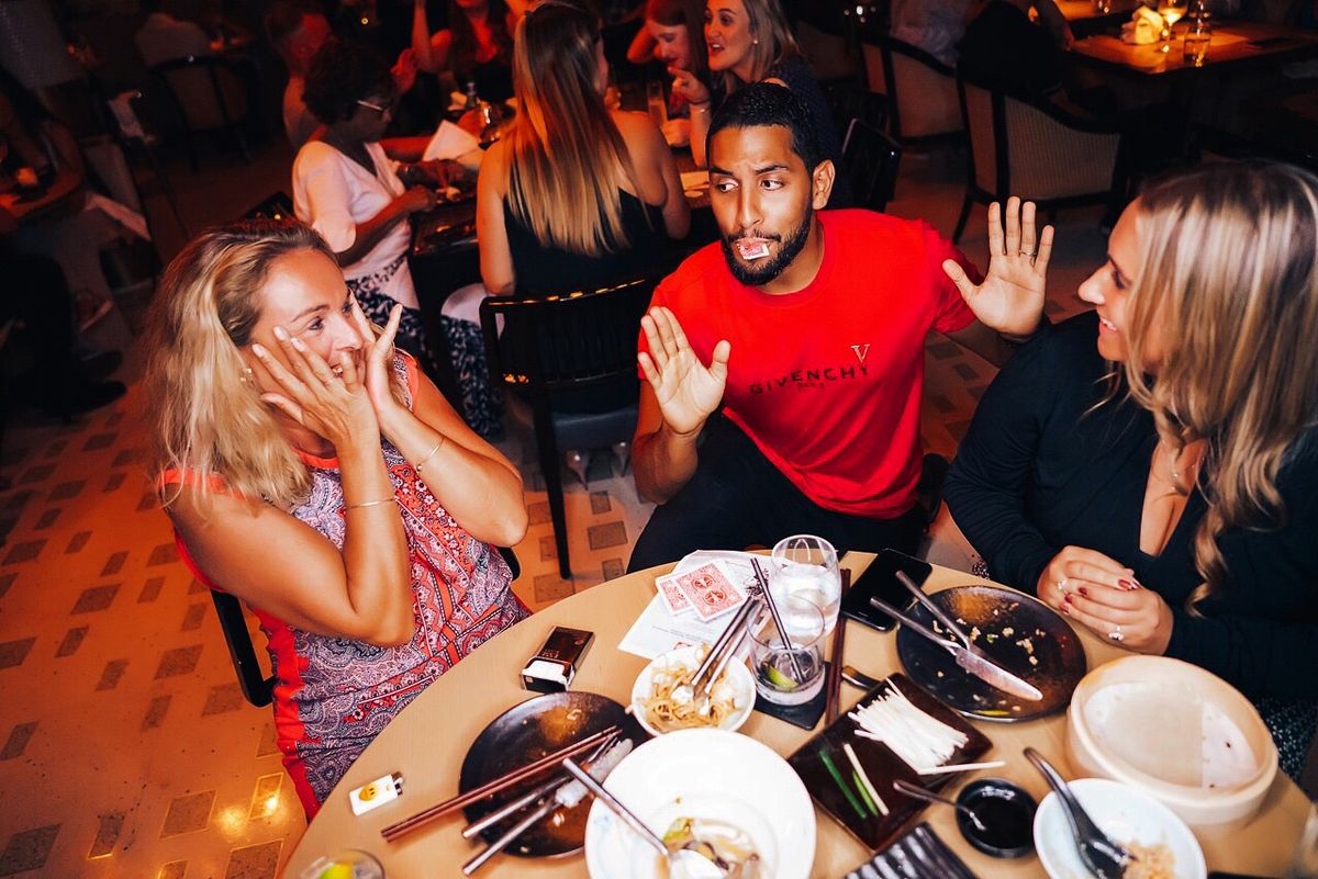 Stunned guests around a table at a private reception